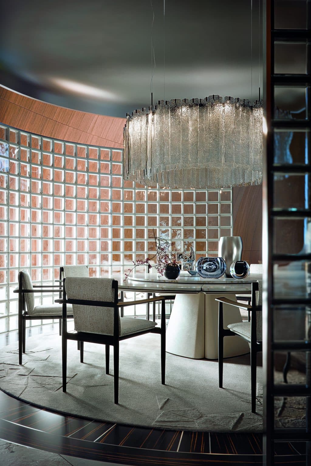 Sculptural dining chairs around a round table under ambient light
