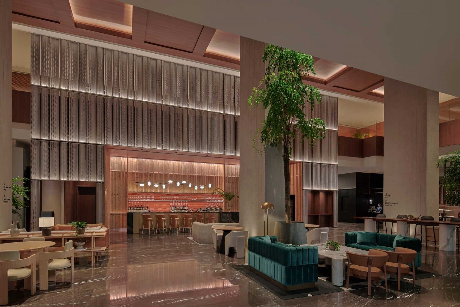 City hotel lounge with a long banquette and warm palette