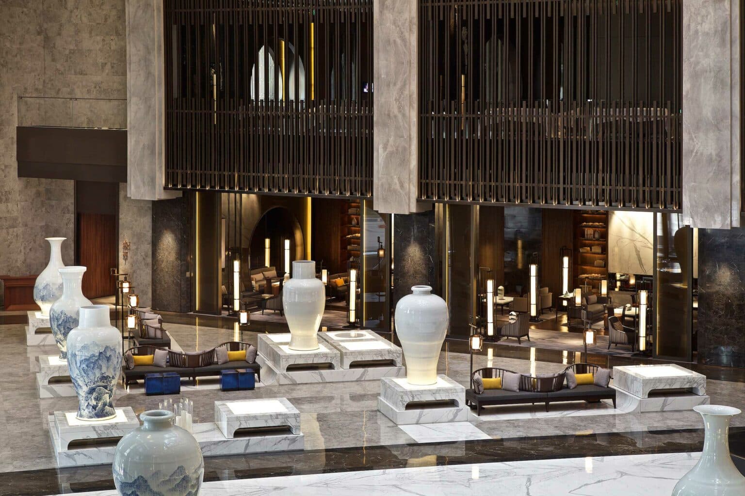 Grand hotel lobby with bespoke lounge groupings beneath a coffered ceiling