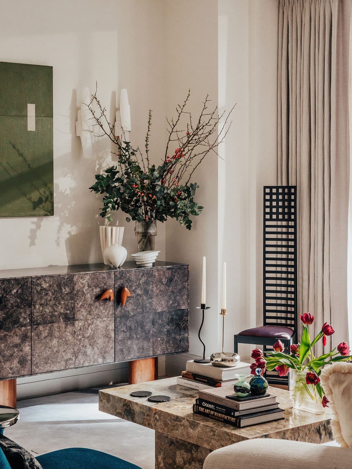 Reading corner with a tailored armchair beside full-height glazing