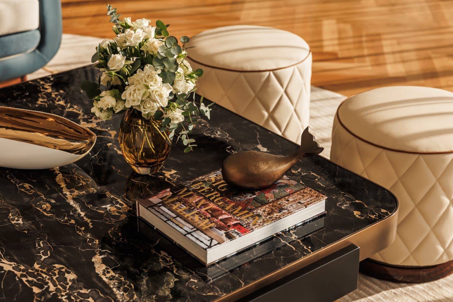 Detail of layered cushions and a marble side table