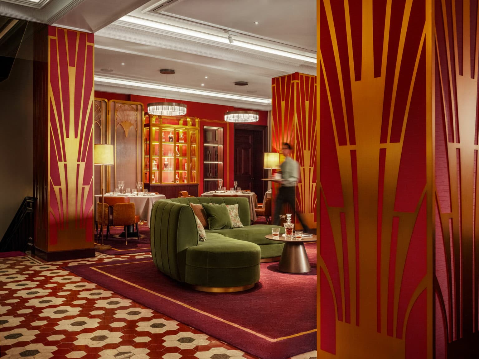 Club lounge with deep armchairs, layered lighting and a curated gallery wall