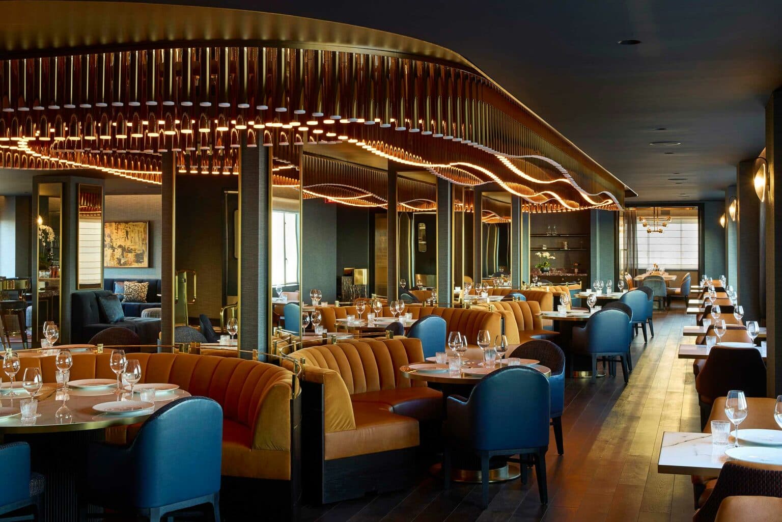Club dining room with banquette seating and pendant lighting