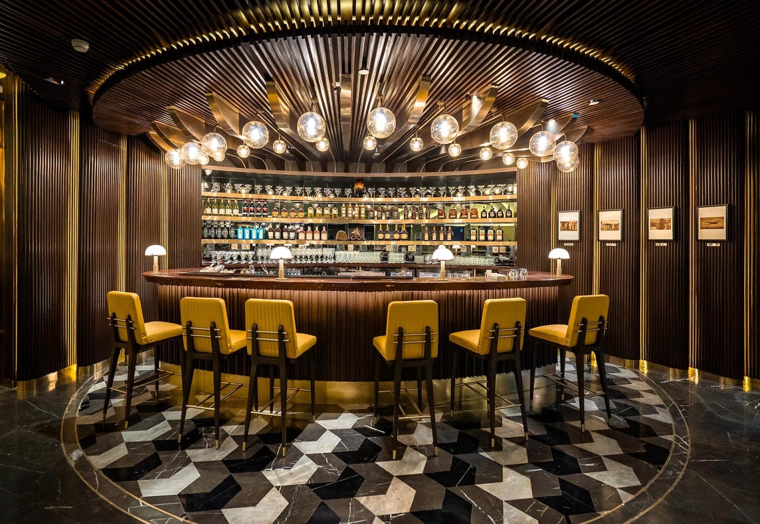 Bar lounge with amber lighting and upholstered stools