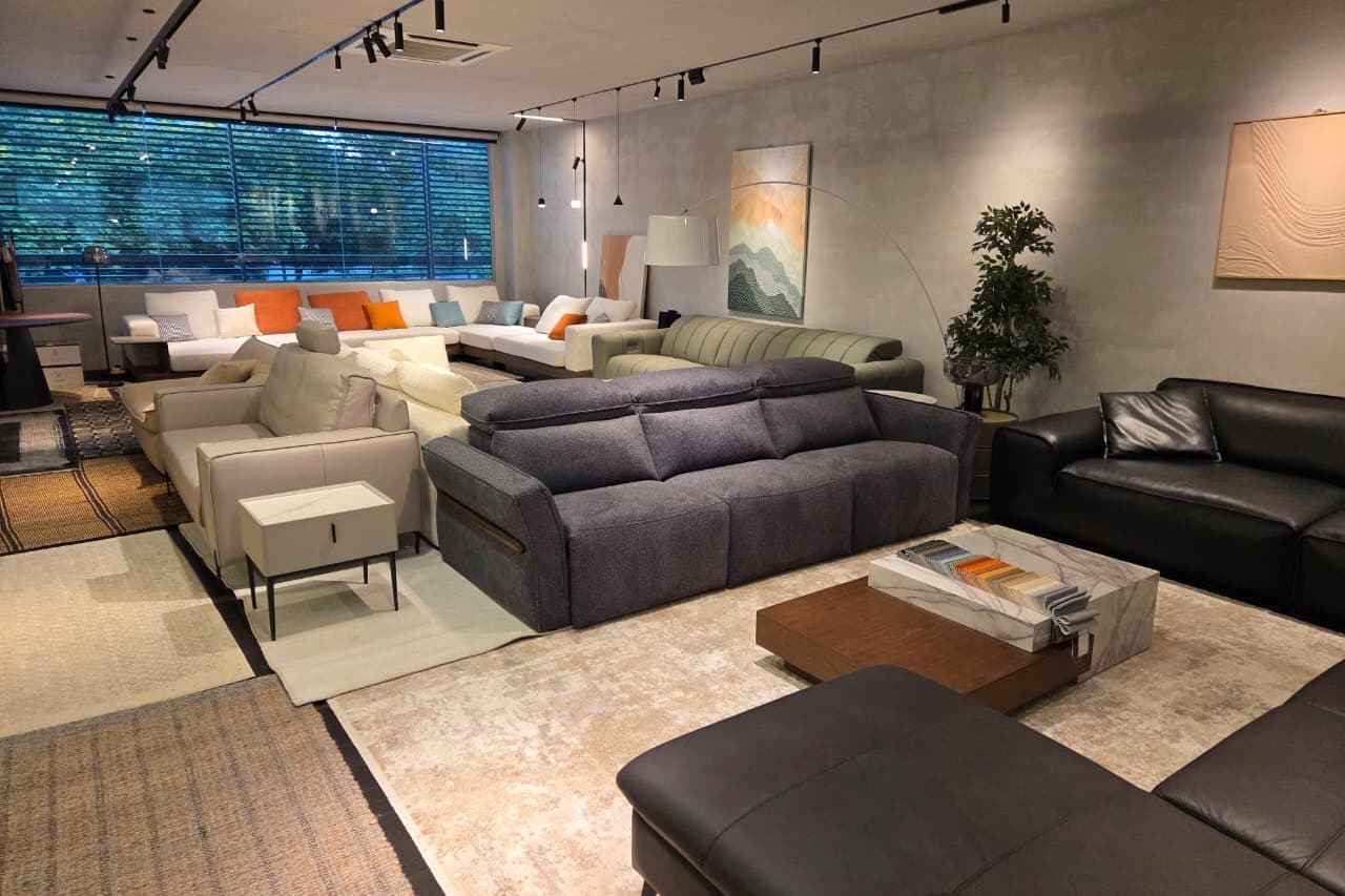 Seremban 2 showroom floor with sofas in fabric and leather, rugs and track lighting