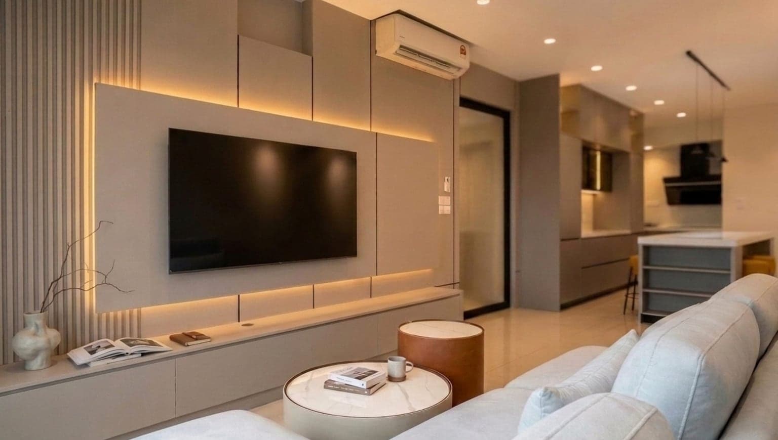 Living room with a backlit feature wall, built-in TV console and cream sofa