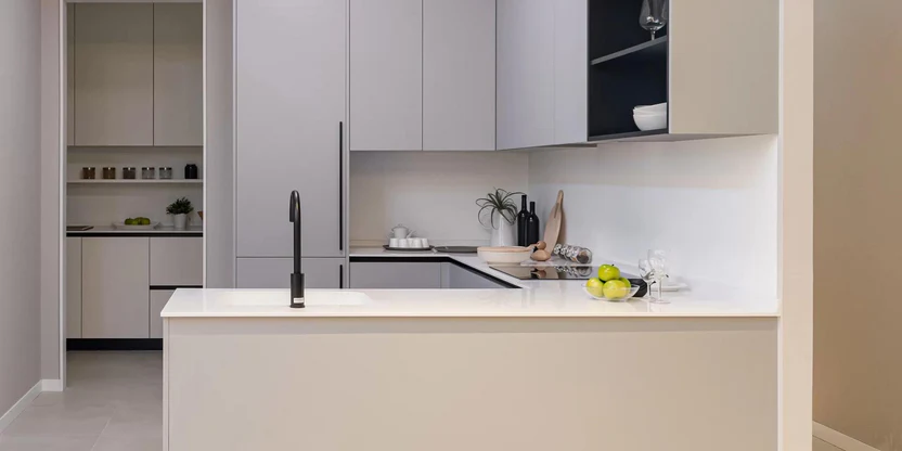 Minimal kitchen with warm cabinetry and a clean island counter